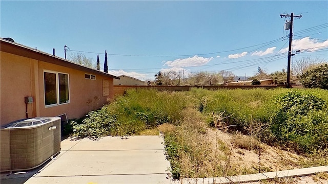 view of yard featuring central AC and a patio area