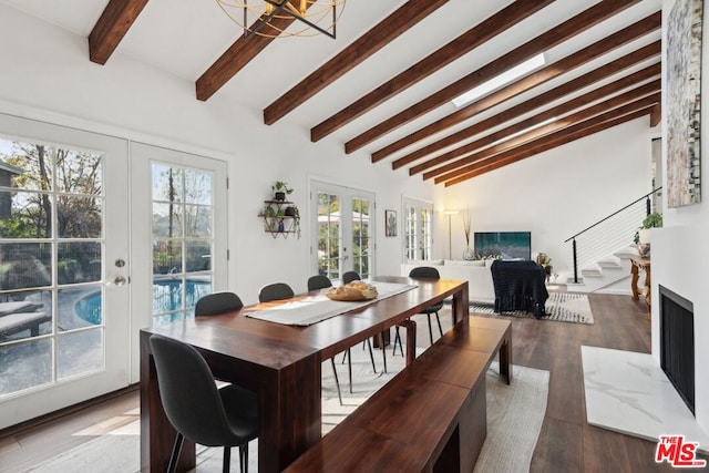 dining area with hardwood / wood-style flooring, a chandelier, french doors, and vaulted ceiling with beams