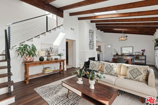 living room featuring a skylight, dark wood-type flooring, and a notable chandelier