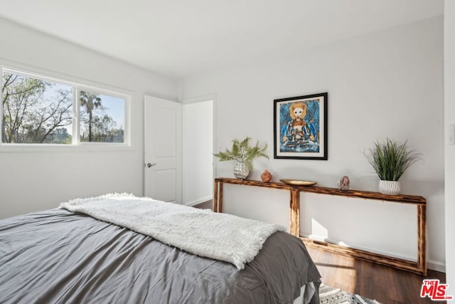 bedroom with wood-type flooring