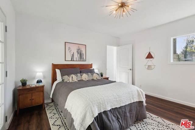 bedroom with dark hardwood / wood-style floors