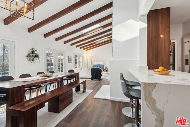 dining space featuring beamed ceiling, an inviting chandelier, dark wood-type flooring, high vaulted ceiling, and french doors