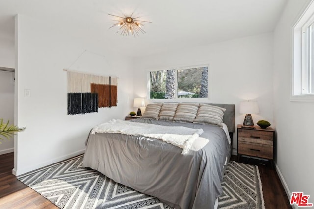 bedroom with dark wood-type flooring