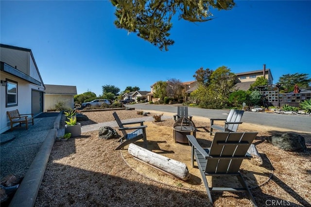 view of yard with an outdoor fire pit