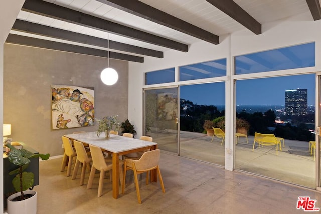 dining area featuring beam ceiling