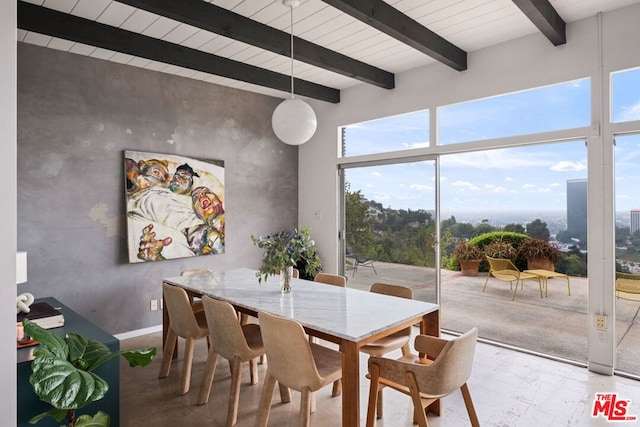 dining space with beam ceiling