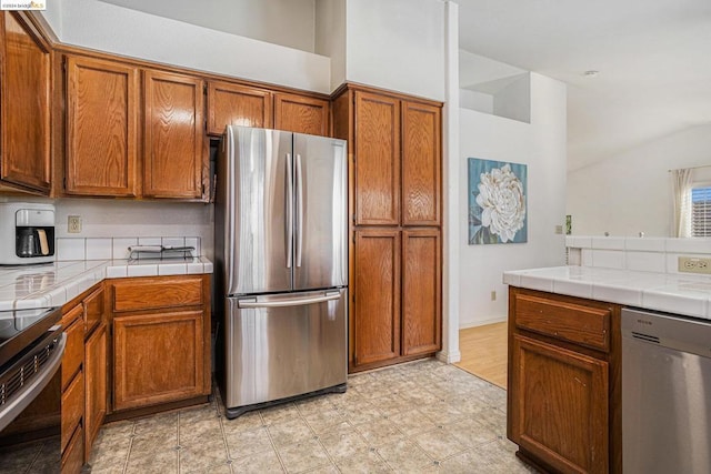 kitchen featuring tile counters and appliances with stainless steel finishes