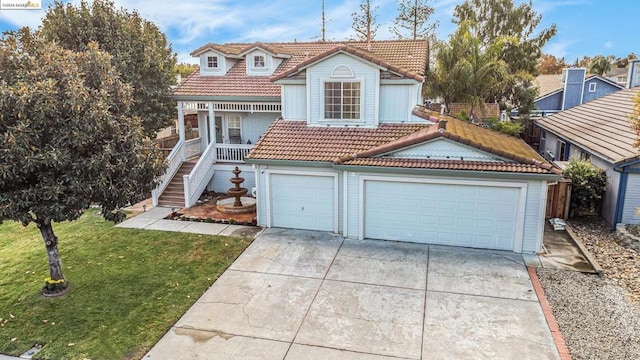 view of front of home featuring a front yard and a garage