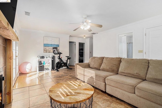 living room featuring ceiling fan, light tile patterned floors, and ornamental molding