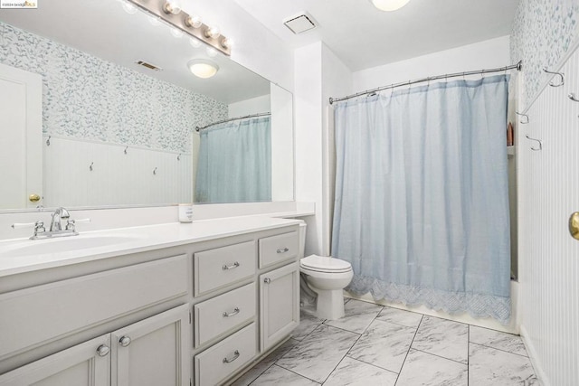 full bathroom featuring shower / bath combo with shower curtain, vanity, and toilet