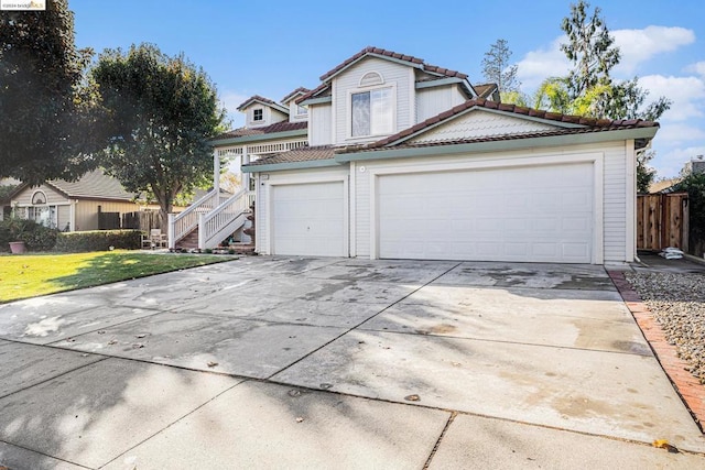 view of property featuring a front lawn and a garage