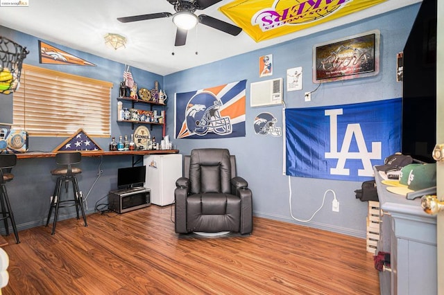 living area with hardwood / wood-style flooring and ceiling fan