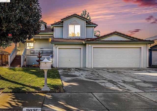 view of property with a yard and a garage