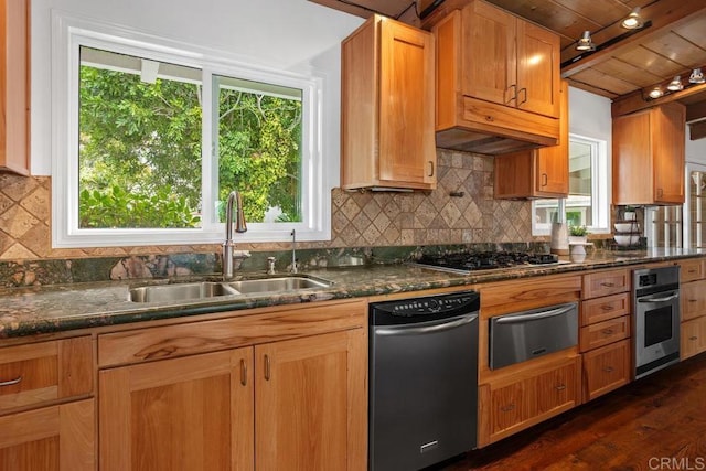 kitchen with backsplash, sink, dark stone counters, stainless steel appliances, and dark hardwood / wood-style flooring