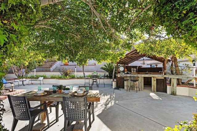 view of patio / terrace featuring a pergola and a bar