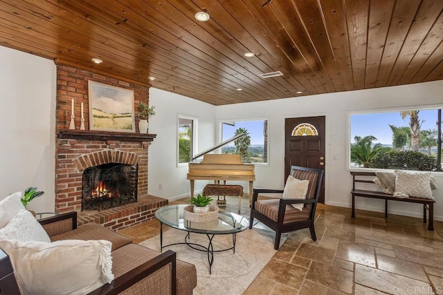 sitting room featuring a brick fireplace and wooden ceiling