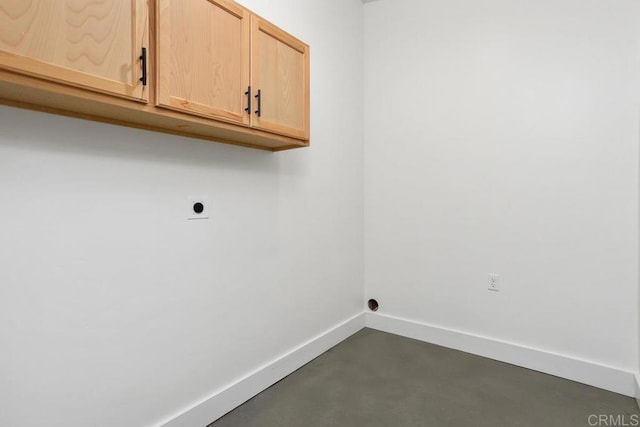 clothes washing area with cabinets and hookup for an electric dryer