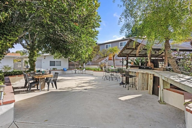 view of community with an outdoor bar, a gazebo, and a patio