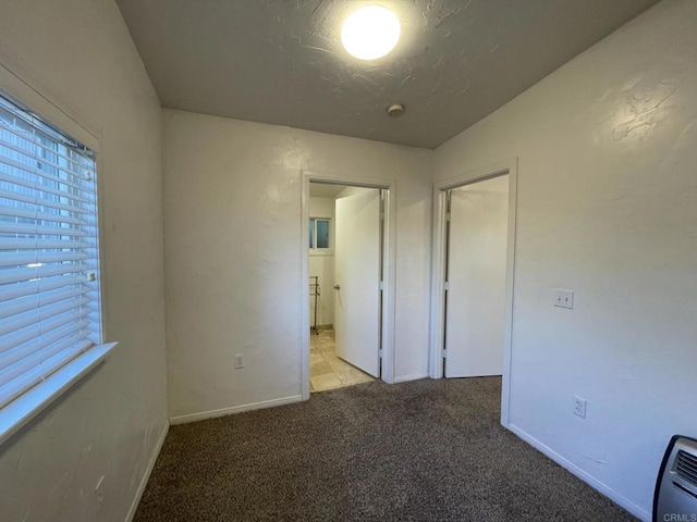 unfurnished bedroom featuring a closet and light carpet