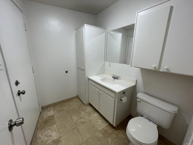 bathroom featuring toilet and vanity