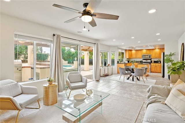 tiled living room with ceiling fan