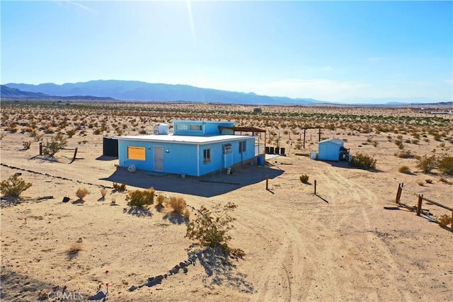 exterior space featuring a mountain view and a storage unit