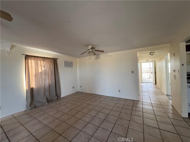 spare room featuring ceiling fan and light tile patterned flooring