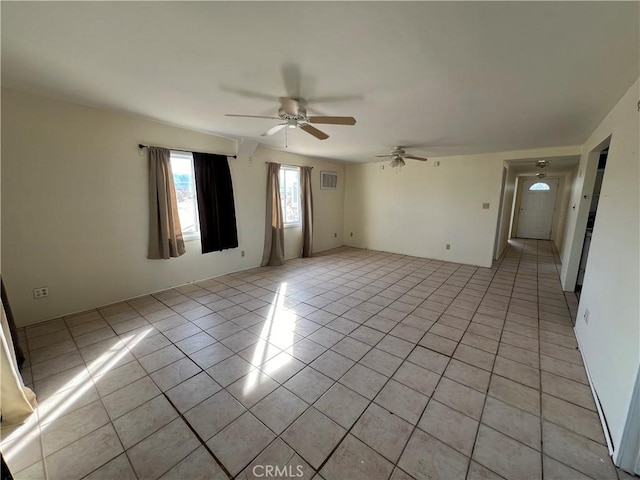 unfurnished room featuring light tile patterned floors and ceiling fan