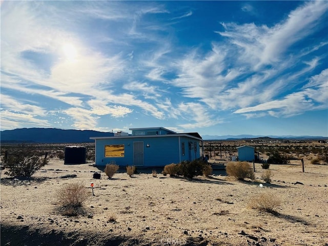 rear view of property with a mountain view