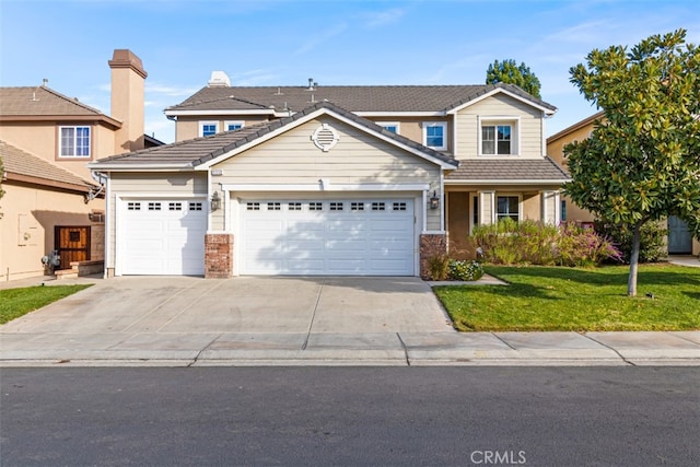 view of front of house with a front yard and a garage