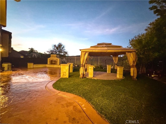 exterior space with a gazebo, cooling unit, a patio, and an outdoor fireplace