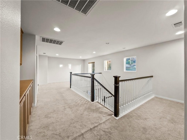 corridor with light colored carpet