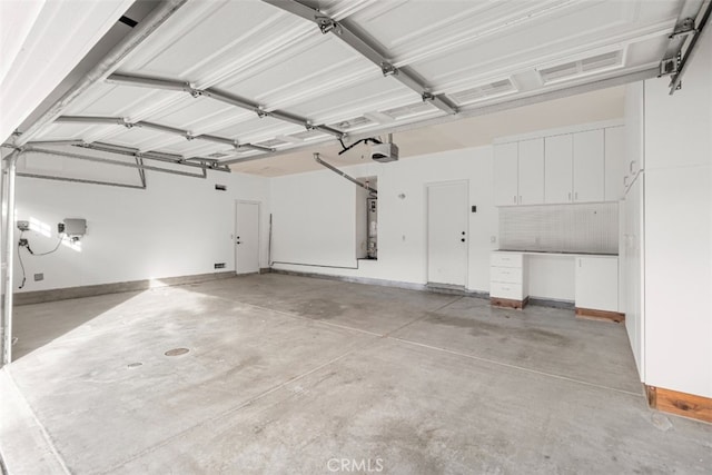 garage featuring a garage door opener and water heater