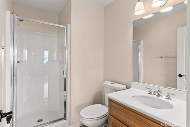 bathroom with an enclosed shower, vanity, and toilet