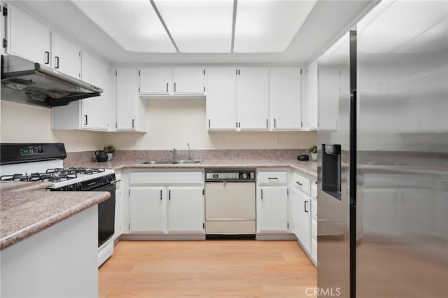 kitchen featuring white appliances, sink, light wood-type flooring, and white cabinets