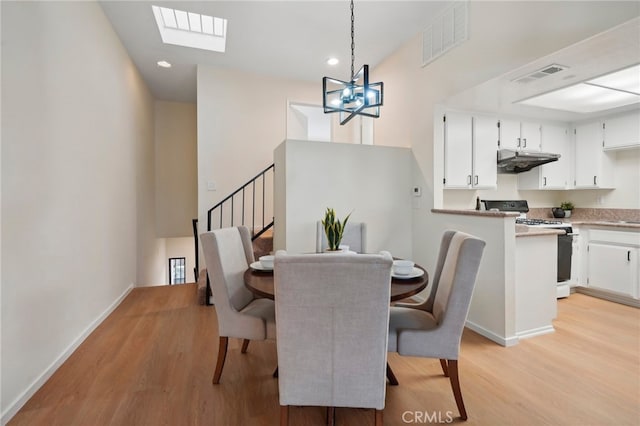 dining area with an inviting chandelier and light wood-type flooring