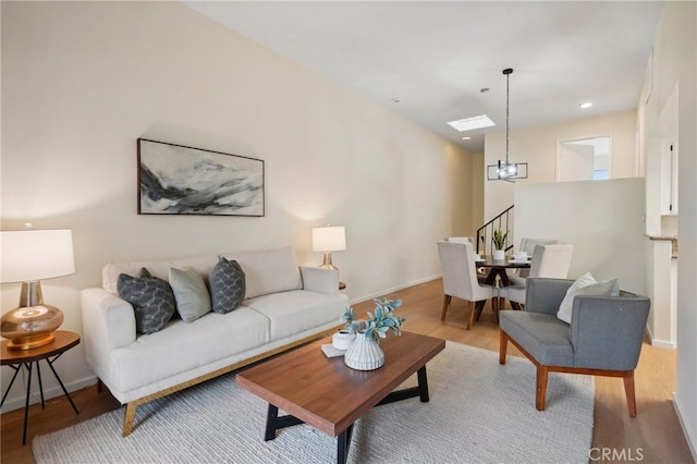 living room featuring a notable chandelier and wood-type flooring