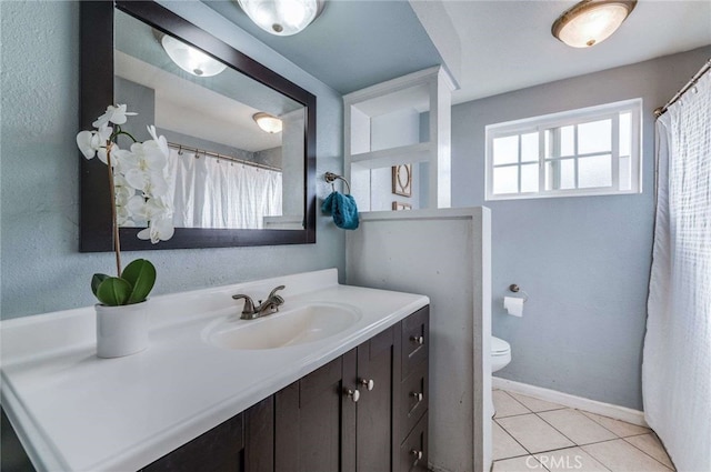 bathroom with vanity, toilet, and tile patterned flooring