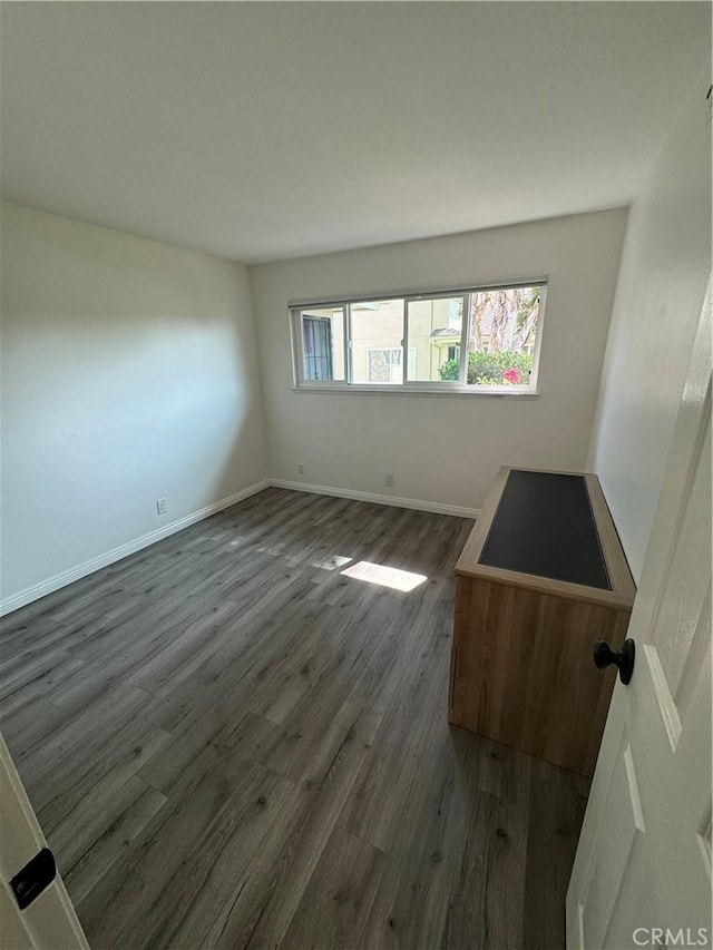 unfurnished room with dark hardwood / wood-style floors