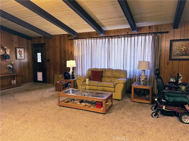 carpeted living room with beam ceiling, wooden ceiling, and wooden walls