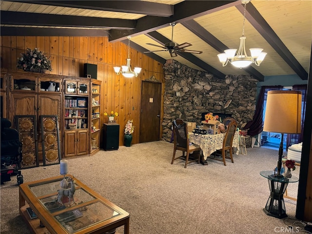 carpeted living room featuring lofted ceiling with beams, wooden walls, wooden ceiling, and ceiling fan with notable chandelier