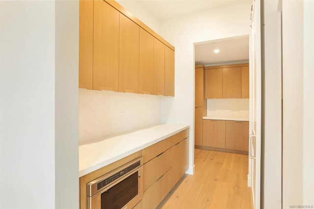 kitchen featuring light brown cabinets and light hardwood / wood-style floors