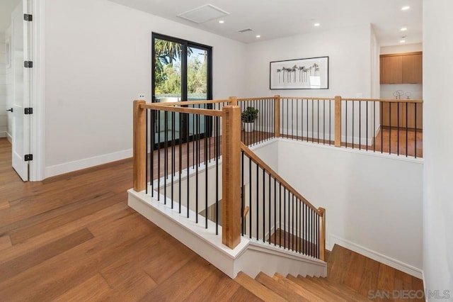 staircase with hardwood / wood-style flooring