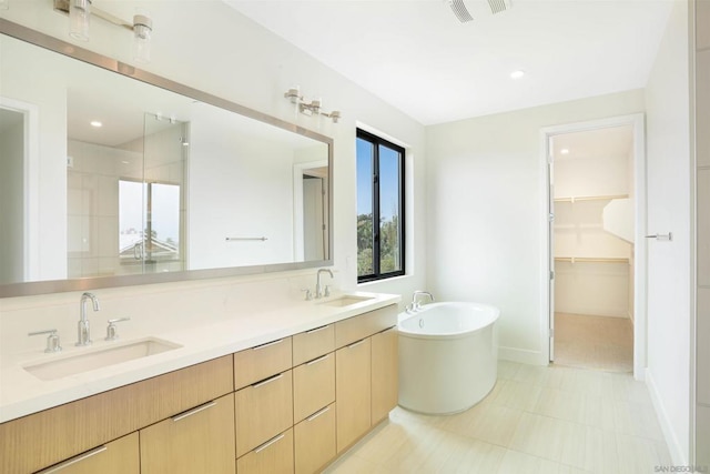 bathroom with vanity and independent shower and bath