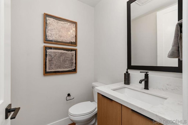 bathroom with toilet and vanity