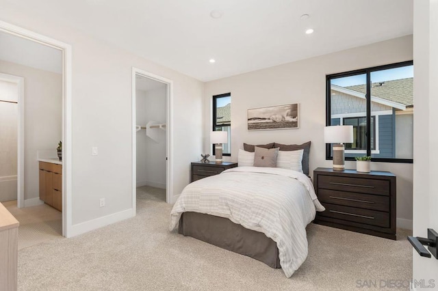 carpeted bedroom with a spacious closet and a closet