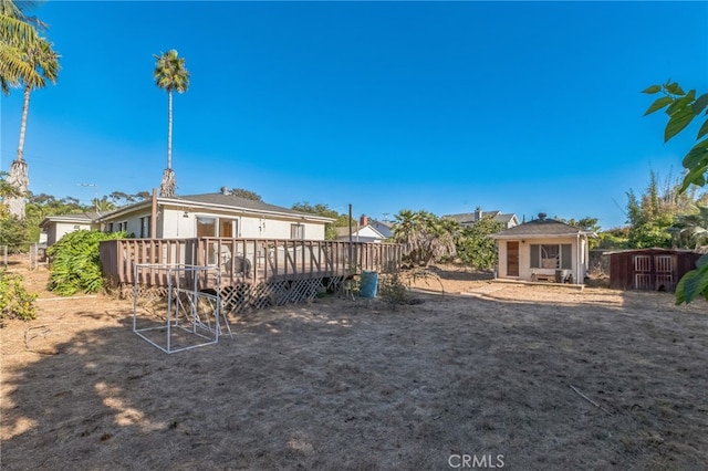 view of yard featuring a wooden deck and a storage shed