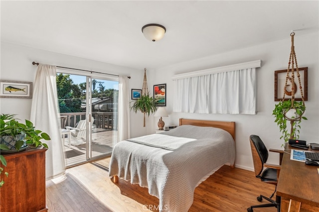 bedroom with access to outside and light wood-type flooring