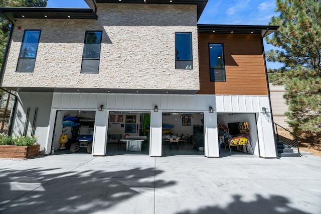 rear view of property featuring a garage