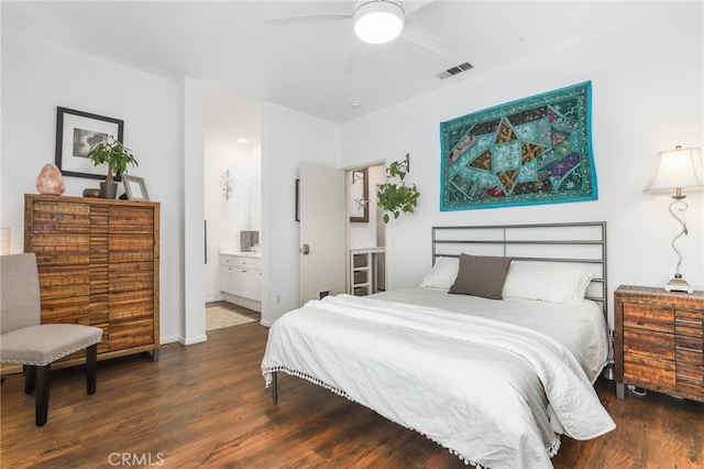 bedroom with dark hardwood / wood-style floors, connected bathroom, and ceiling fan